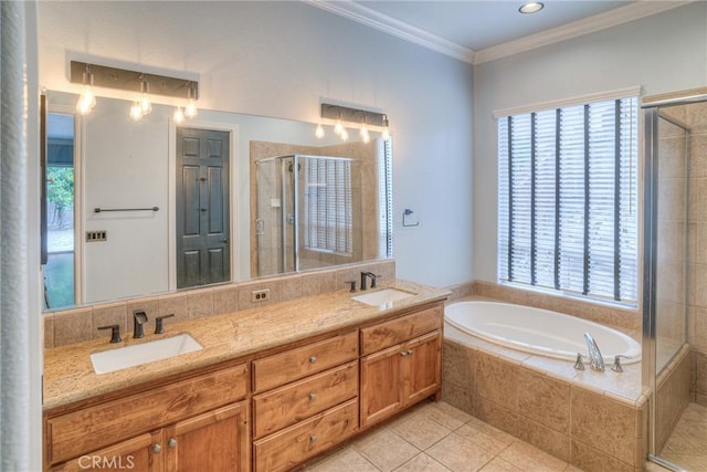 bathroom with crown molding, a stall shower, a garden tub, and a sink