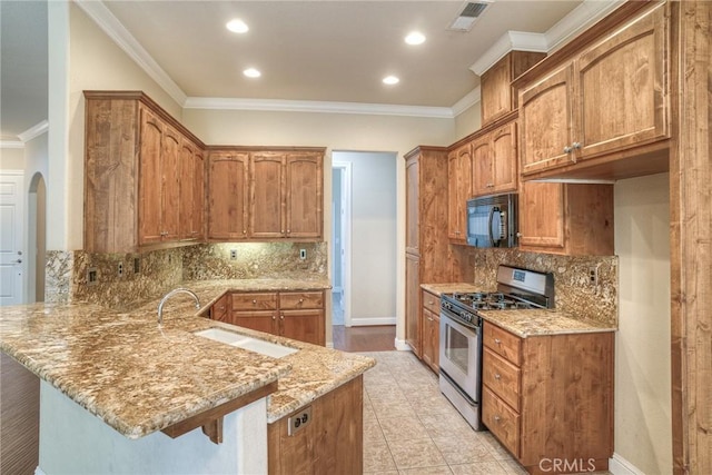 kitchen featuring a breakfast bar, a peninsula, light stone countertops, stainless steel range with gas cooktop, and black microwave