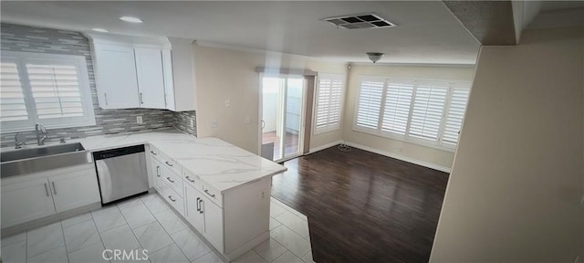 kitchen featuring visible vents, white cabinets, dishwasher, and a sink