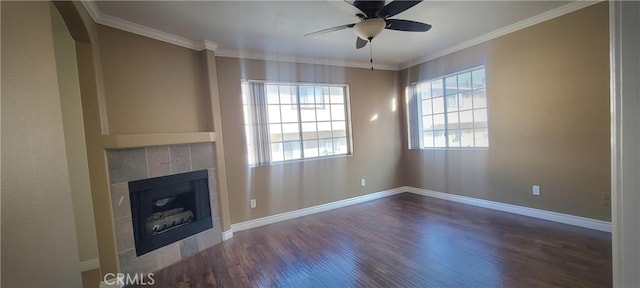 unfurnished living room featuring wood finished floors, crown molding, a fireplace, and baseboards