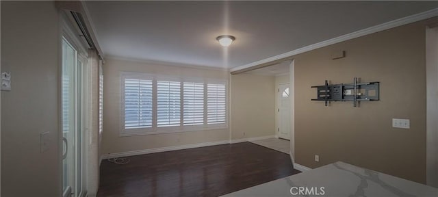 entryway with crown molding, baseboards, and wood finished floors