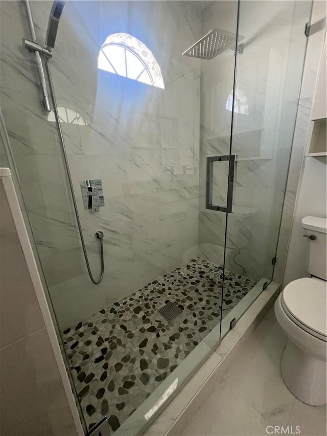 full bath featuring toilet and a stall shower