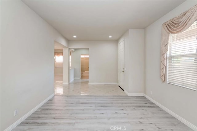 unfurnished room featuring recessed lighting, baseboards, and light wood finished floors