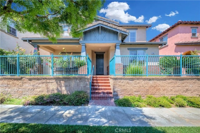 view of front facade featuring fence and stucco siding