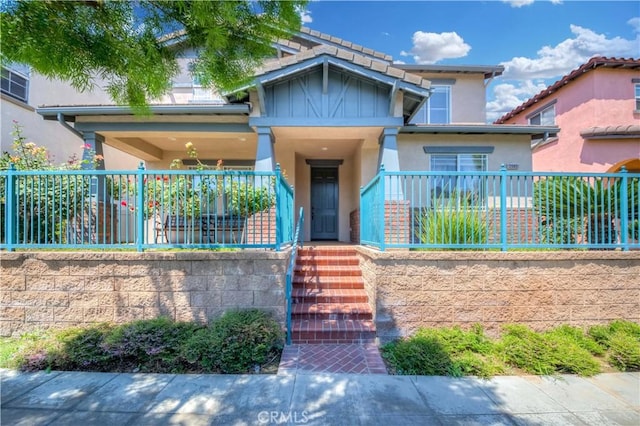 view of front of property with fence and stucco siding