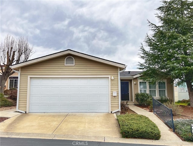 single story home with a garage and concrete driveway