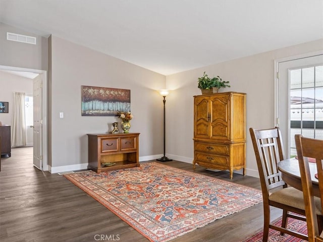 interior space featuring baseboards, visible vents, and dark wood-style flooring