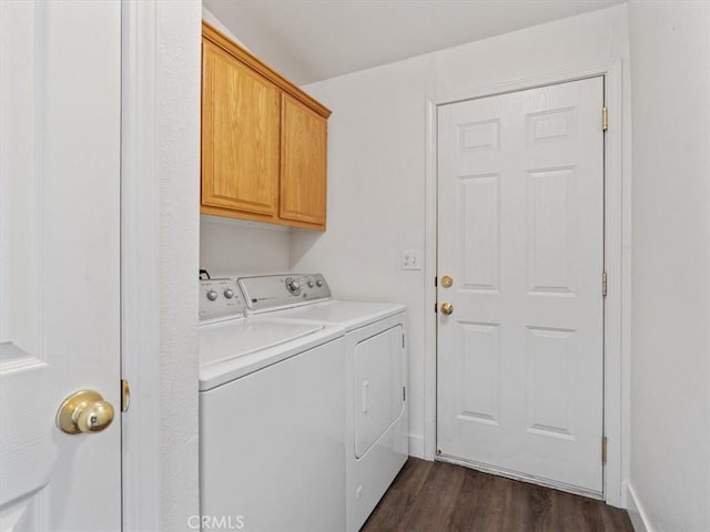 laundry area featuring dark wood-type flooring, washer and dryer, and cabinet space