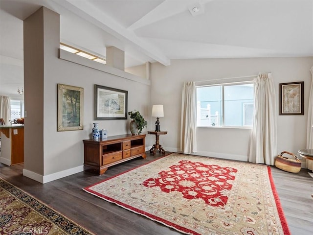 foyer entrance featuring lofted ceiling with beams, a wealth of natural light, and wood finished floors