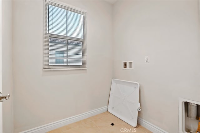 laundry room with washer hookup, laundry area, baseboards, and light tile patterned floors