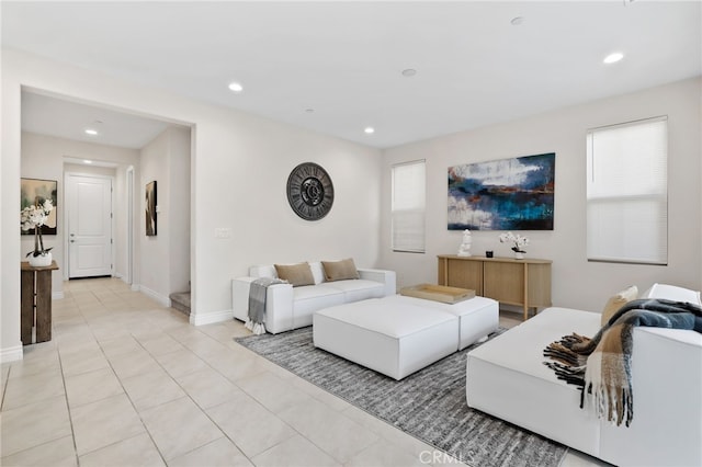 living area with baseboards, light tile patterned flooring, a wealth of natural light, and recessed lighting