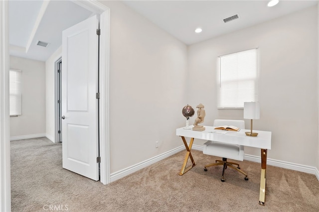 carpeted home office featuring visible vents and baseboards