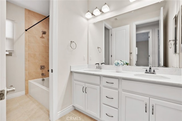 bathroom featuring tile patterned flooring, bathtub / shower combination, a sink, and double vanity