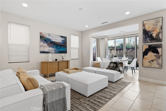 living area featuring recessed lighting, visible vents, baseboards, and light tile patterned flooring