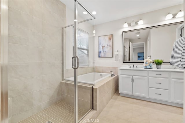 full bathroom featuring double vanity, tile patterned floors, a garden tub, a shower stall, and a sink