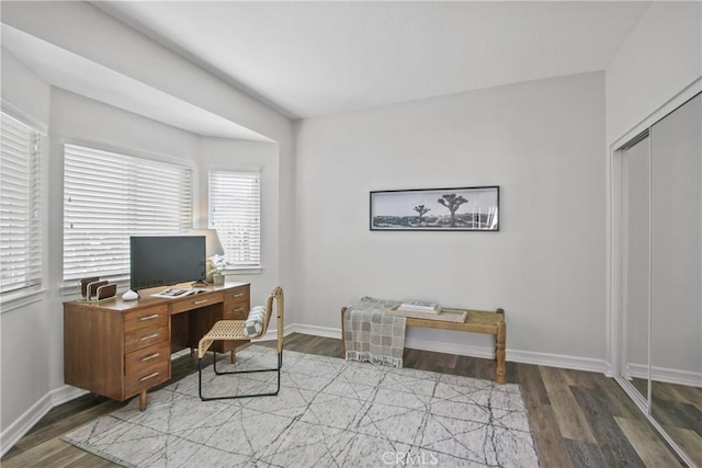 home office featuring baseboards and wood finished floors