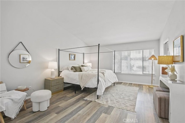 bedroom featuring baseboards and wood finished floors