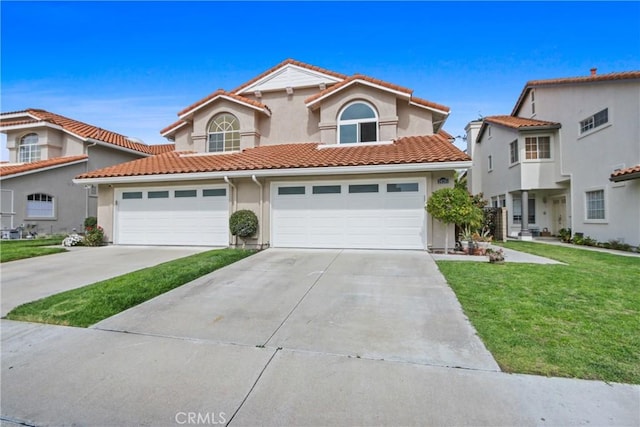 mediterranean / spanish-style home with a tiled roof, a front yard, driveway, and stucco siding