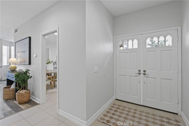 entrance foyer with tile patterned flooring, visible vents, and baseboards