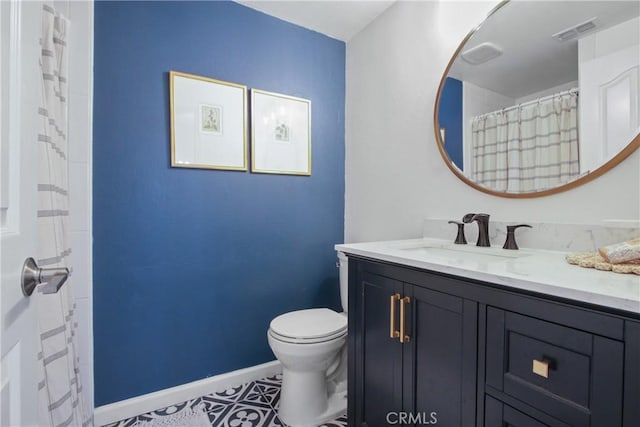 bathroom featuring baseboards, visible vents, vanity, and toilet