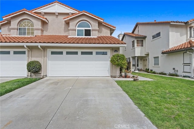 mediterranean / spanish house with stucco siding, concrete driveway, a front yard, a garage, and a tiled roof