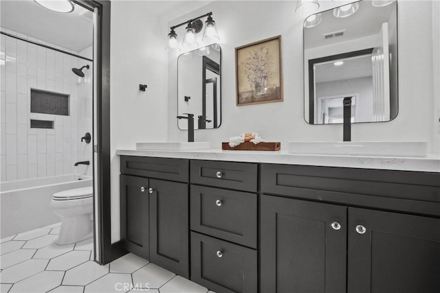 bathroom with double vanity, visible vents, toilet, tile patterned floors, and a sink