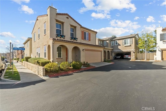 view of front of property featuring stucco siding, a residential view, and a tile roof