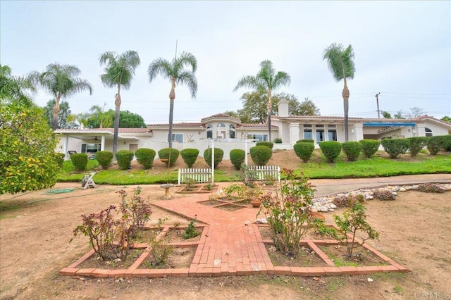 view of community with a garden and fence