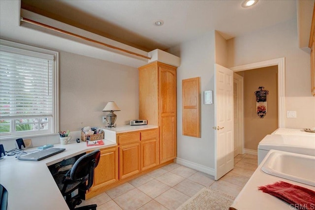 office space featuring light tile patterned floors, baseboards, washing machine and dryer, a sink, and recessed lighting