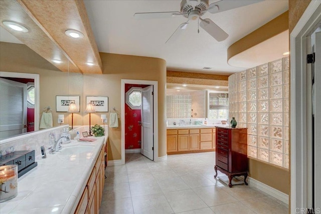 bathroom featuring vanity, baseboards, and tile patterned floors