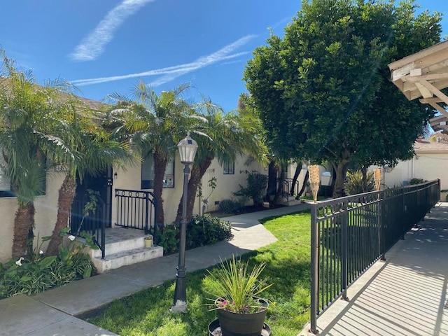 exterior space featuring a fenced front yard and stucco siding