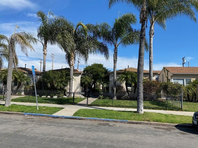 exterior space with a fenced front yard and a yard