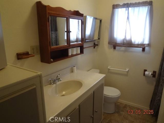 bathroom with toilet and vanity