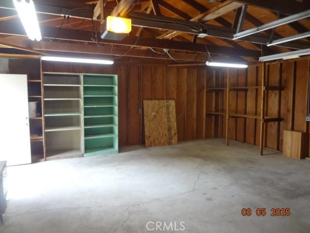 garage featuring wood walls and a garage door opener