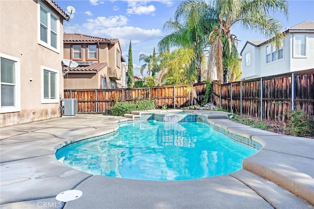 view of pool with a patio, a pool with connected hot tub, central AC unit, and a fenced backyard