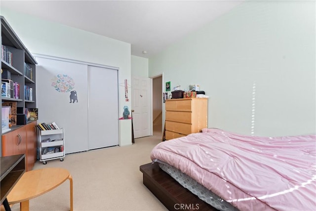 bedroom with a closet and light colored carpet