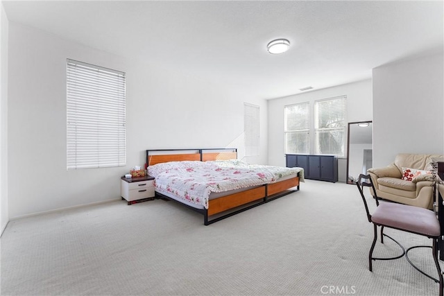 carpeted bedroom with visible vents