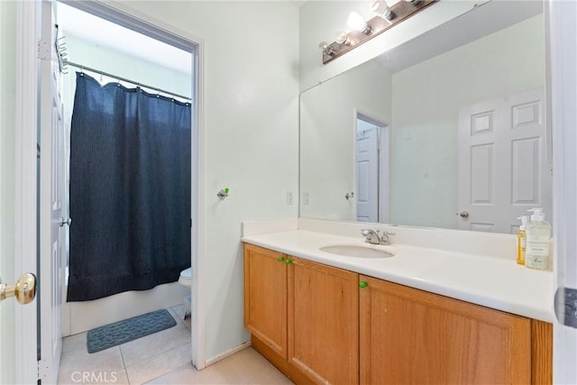 bathroom with curtained shower, toilet, vanity, and tile patterned flooring