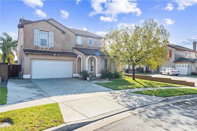 view of front of house with a tiled roof, concrete driveway, a front yard, stucco siding, and an attached garage