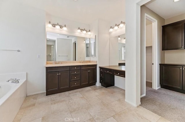 full bathroom featuring double vanity, a garden tub, baseboards, and a sink