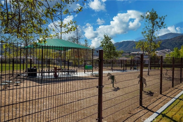 view of community featuring fence and a mountain view