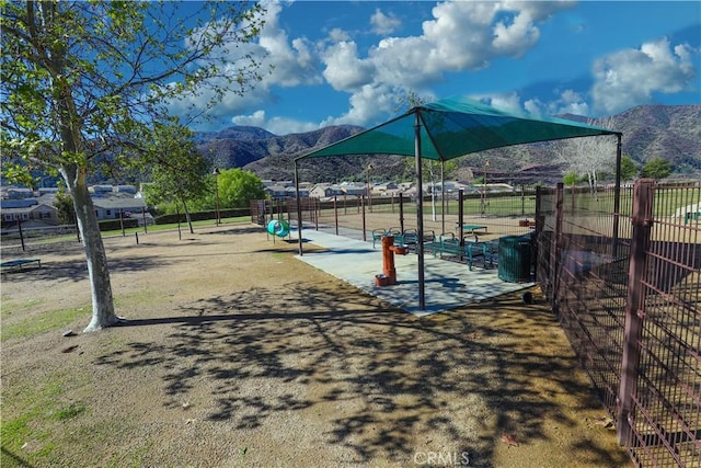 exterior space featuring fence and a mountain view