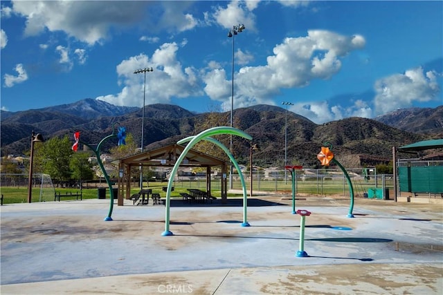 view of home's community featuring fence and a mountain view