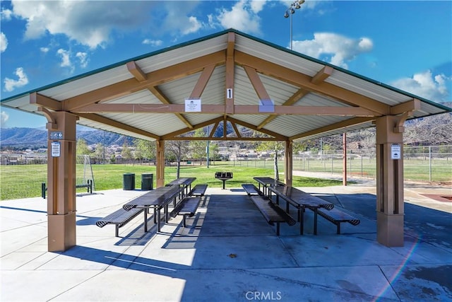 surrounding community featuring a yard, fence, a gazebo, and a mountain view