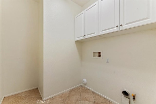 laundry area with washer hookup, light tile patterned floors, hookup for a gas dryer, cabinet space, and baseboards