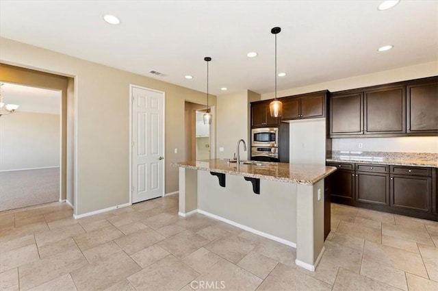 kitchen featuring stainless steel appliances, recessed lighting, visible vents, and dark brown cabinets