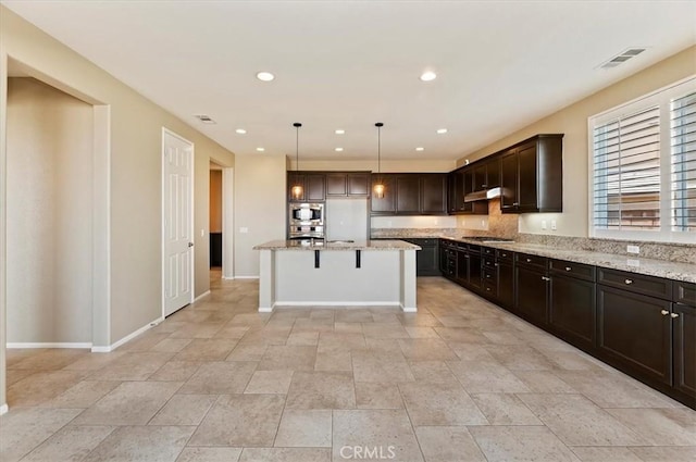 kitchen featuring under cabinet range hood, stainless steel appliances, dark brown cabinets, and recessed lighting