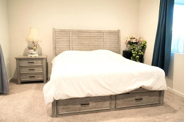 carpeted bedroom featuring baseboards