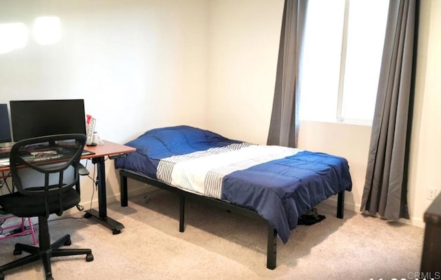 carpeted bedroom featuring baseboards