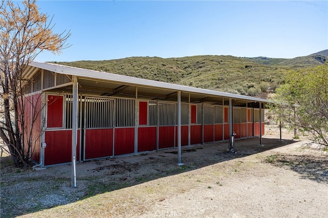 view of stable featuring a mountain view